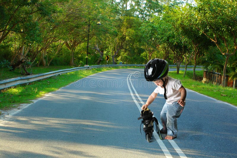 Toddler ready for rollerskating on nature