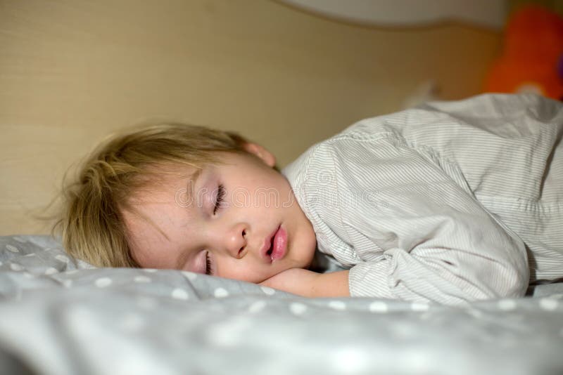 Toddler Sleeping at Home at Night, Hugging Little Toy Stock Photo