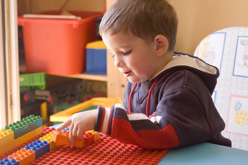 Toddler with toys in his room royalty free stock images
