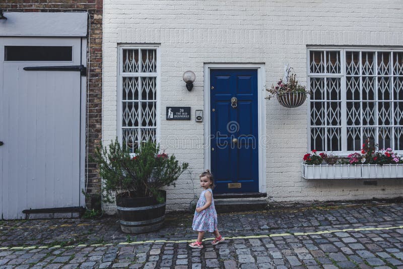 Toddler walking past the mews house in Bayswater, London