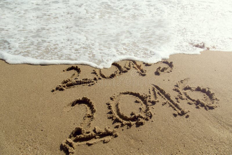 Numbers 2015 and 2016 written on the sand, waves erasing 2015, as new year is comming. Numbers 2015 and 2016 written on the sand, waves erasing 2015, as new year is comming.