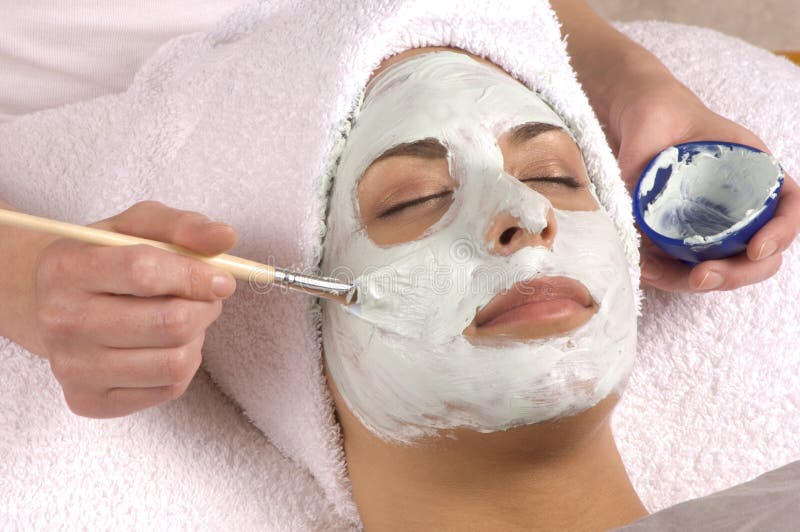 Young woman at day spa salon with full application of organic facial mask. Young woman at day spa salon with full application of organic facial mask