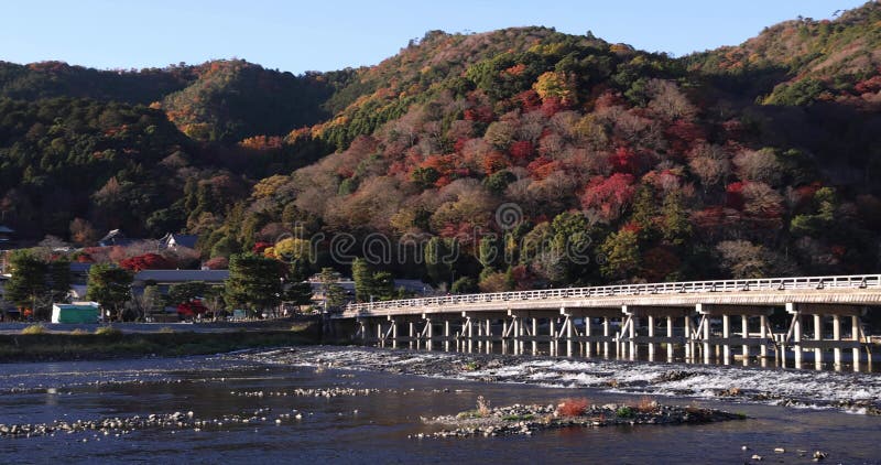 Togetsukyo bridge near Katsuragawa river in Kyoto in autumn panning