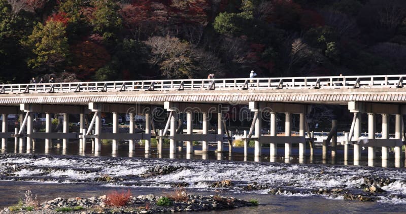 Togetsukyo bridge near Katsuragawa river in Kyoto in autumn telephoto shot panning. Togetsukyo bridge near Katsuragawa river in Kyoto. High quality 4k footage