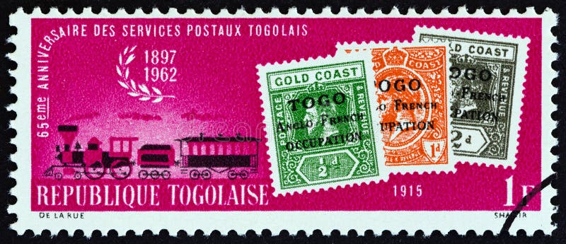 TOGO - CIRCA 1963: A stamp printed in Togo from the "65th Anniversary of Togolese Postal Services " issue shows stamps of 1915 and steam mail train, circa 1963. TOGO - CIRCA 1963: A stamp printed in Togo from the "65th Anniversary of Togolese Postal Services " issue shows stamps of 1915 and steam mail train, circa 1963.