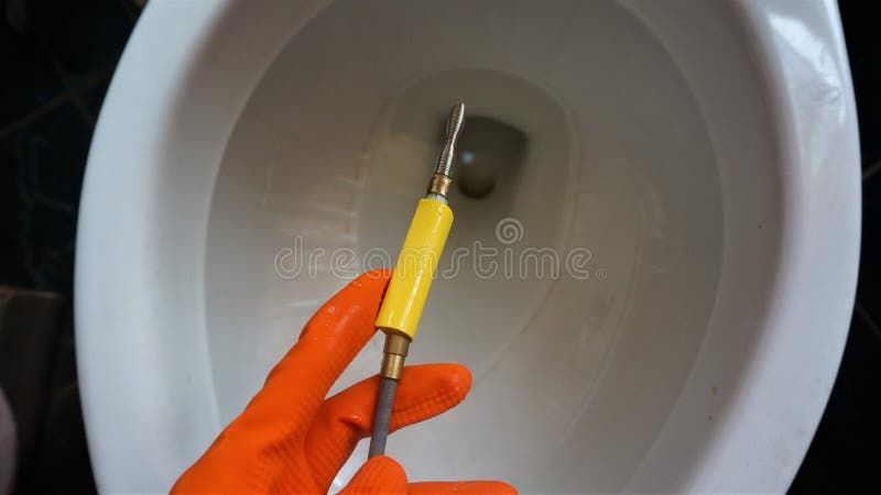 https://thumbs.dreamstime.com/b/toilet-clogged-there-blockage-cleaning-worker-must-wear-orange-gloves-hold-drill-called-iron-snake-201134941.jpg