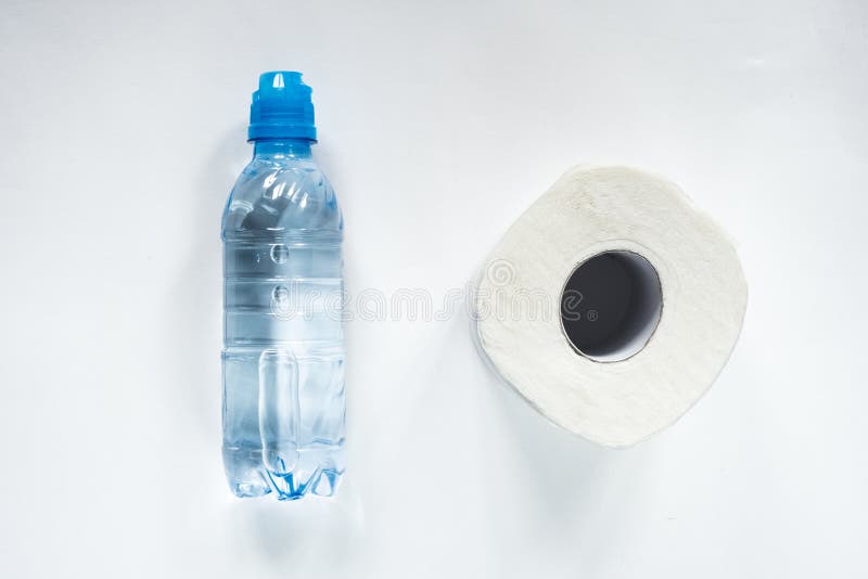 Toilet paper roll and bottle of water on white backgorund. Healthcare medical coronavirus quarantine, hygiene concept. Virus pande