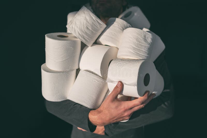 Toilet paper shortage coronavirus panic buying man hoarding carrying many rolls at home in fear of corona virus outbreak