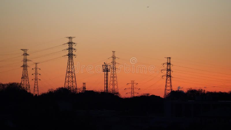 Transmission towers and steel poles before sunrise in Tokyo