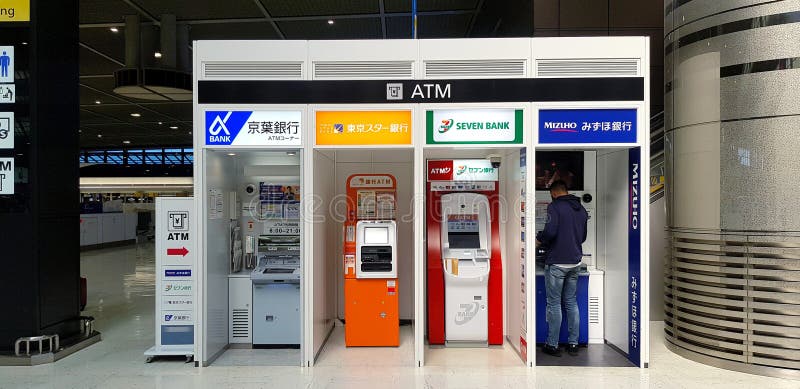 Asian man or tourism deposit and withdraw money from ATM Automatic teller machine to shopping