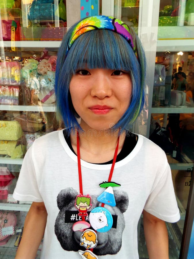 A Japanese girl poses on Takeshita Street in the Harajuku district. This street is famous for anime royalty free stock photos