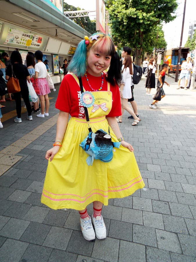 A Japanese girl poses on Takeshita Street in the Harajuku district. This street is famous for anime royalty free stock photography