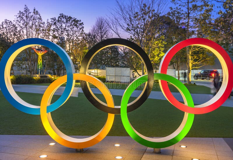 Olympic Rings lighted up at dusk on the japan sport olympic square of Tokyo.