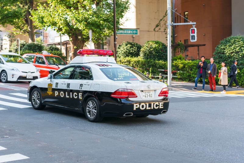 TOKYO, JAPAN - OCTOBER 31, 2017: Police car on city street. Copy royalty free stock photo TOKYO, JAPAN - OCTOBER 31, 2017: Police car on city street. Copy royalty free stock photo