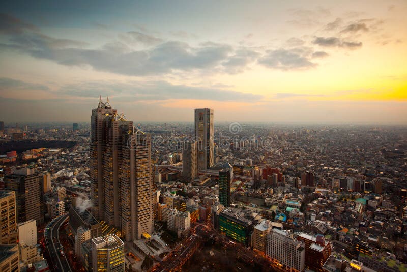 Bird&#x27;s eye view of the southern part of Tokyo, from observatories on the 45th floor of Tokyo Metropolitan Government Building before sunset, Japan. Tokyo Metropolitan Government Building is one of the Tokyo landmarks, located at Shinjuku ward, also referred to as Tokyo City Hall or Tacho for short. The 243 meter tall twin towers and surrounding buildings contain the offices and the assembly hall of the metropolitan government of Tokyo, as well as observatories on the 45th floor of each tower. Bird&#x27;s eye view of the southern part of Tokyo, from observatories on the 45th floor of Tokyo Metropolitan Government Building before sunset, Japan. Tokyo Metropolitan Government Building is one of the Tokyo landmarks, located at Shinjuku ward, also referred to as Tokyo City Hall or Tacho for short. The 243 meter tall twin towers and surrounding buildings contain the offices and the assembly hall of the metropolitan government of Tokyo, as well as observatories on the 45th floor of each tower.