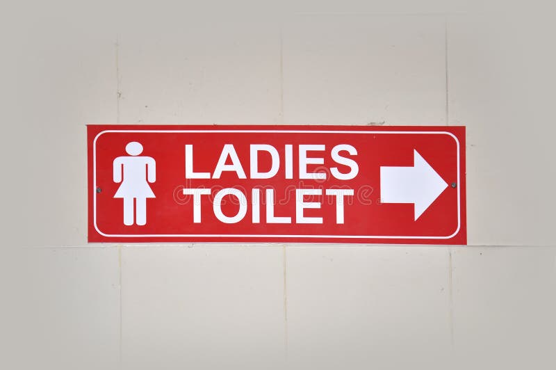 Ladies toilet sign with white tiles background. Ladies toilet sign with white tiles background