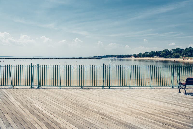 Empty ocean beach boardwalk pier at hot summer day against blue skyÑŽ. Empty ocean beach boardwalk pier at hot summer day against blue skyÑŽ