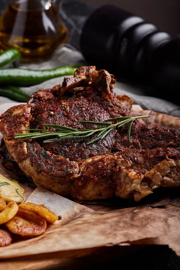 Tomahawk Steak with Vegetables and a Knife on the Table. Grilled Meat with Grilled Vegetables
