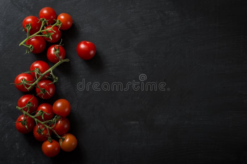 Food Ingredients small Tomatoes on dark background. Food Ingredients small Tomatoes on dark background