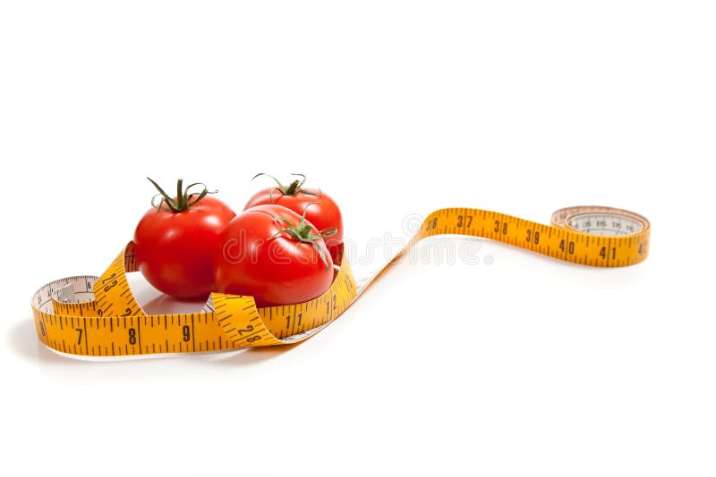 Tomate com uma medida de fita foto de stock Tomate com uma medida de fita foto de stock