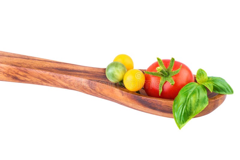 Tomates sur la cuillère en bois images libres de droits Tomates sur la cuillère en bois images libres de droits