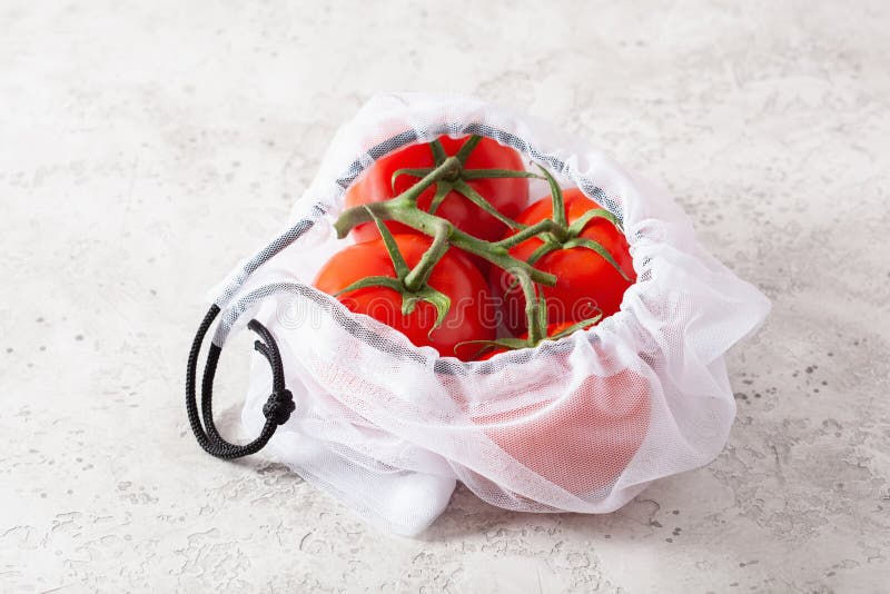 Tomato vegetables in reusable mesh nylon bag, plastic free zero waste concept. Tomato vegetables in reusable mesh nylon bag, plastic free zero waste concept