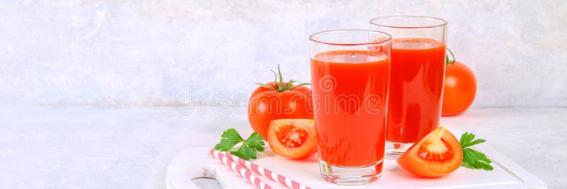 Tomato Juice in Glasses on a Gray Concrete Table. Stock Photo Image