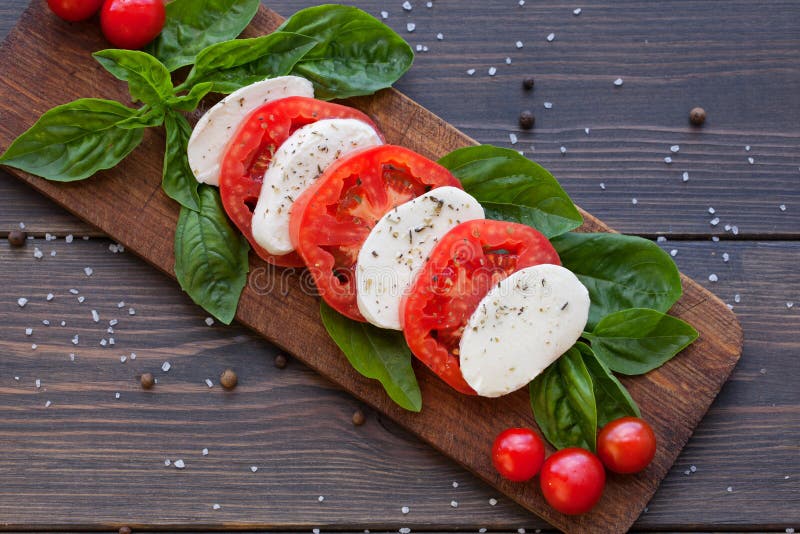 Tomato and Mozzarella Slices with Basil Leaves Stock Photo - Image of