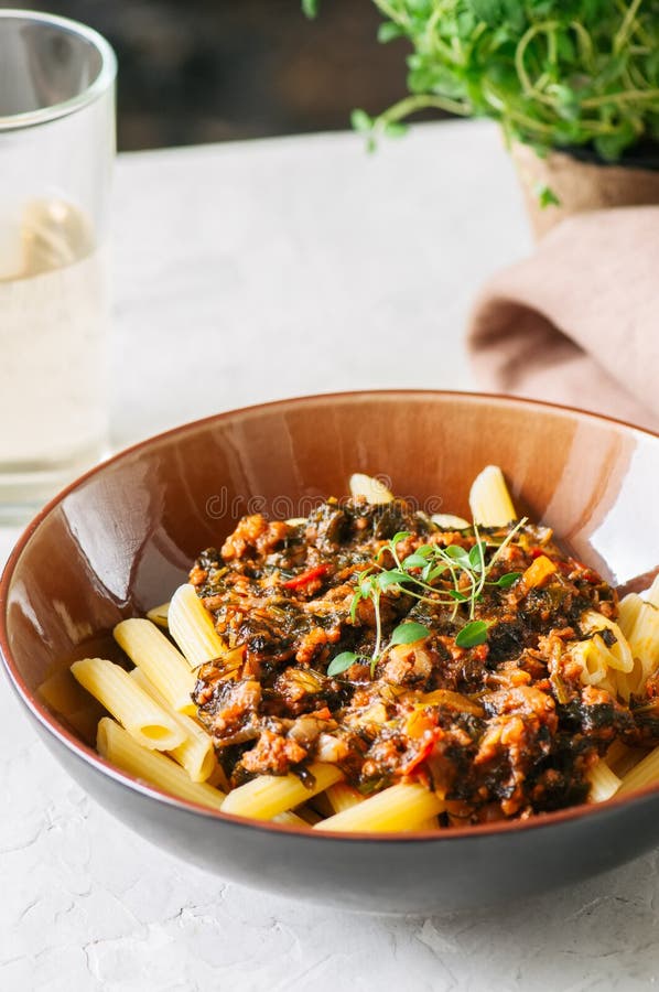 Tomato sauce ground beef pasta on a white stone background. Tone royalty free stock image Tomato sauce ground beef pasta on a white stone background. Tone royalty free stock image