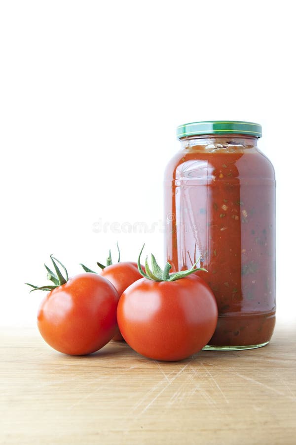 Tomato Sauce and Ripe Tomatoes on Wood