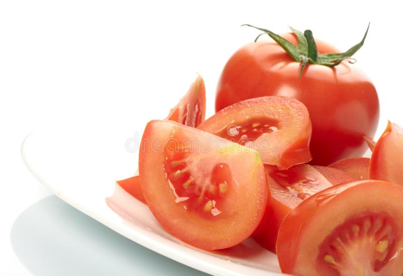 Tomato and slices on plate