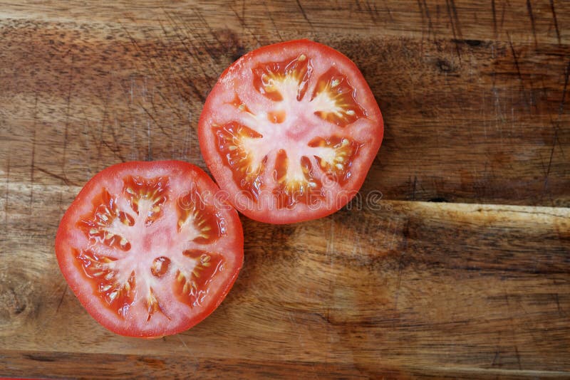 Tomato slices on wooden board