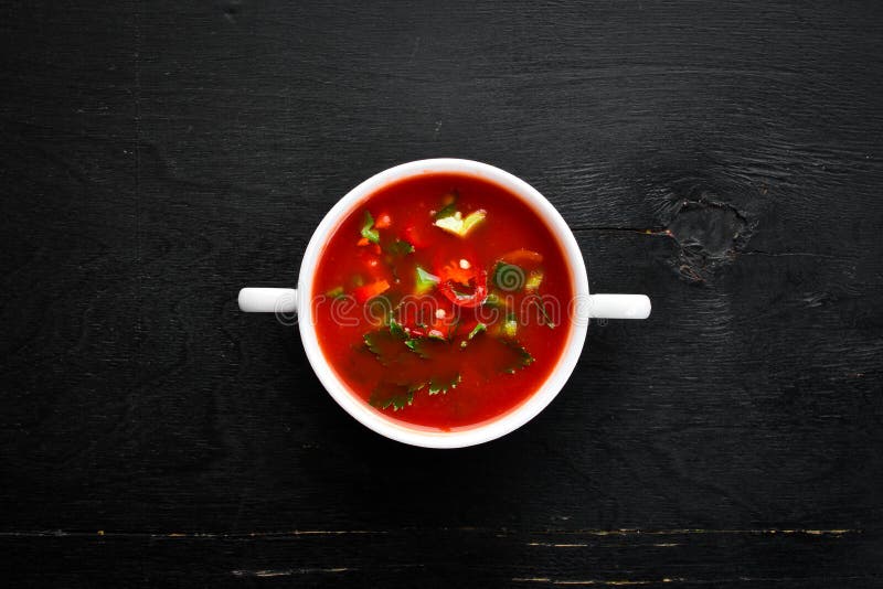 Tomato soup with onion, cucumber and paprika.=