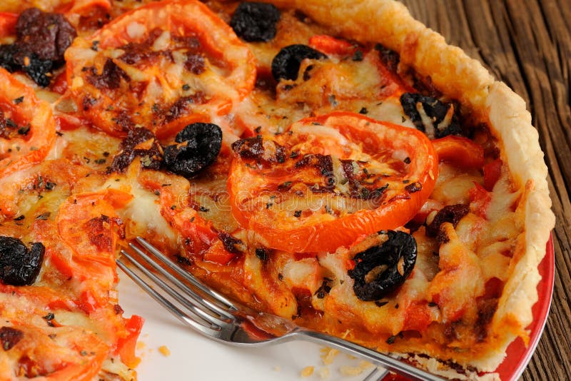 Tomato Tart with Olives and Red Pepper Closeup Macro Stock Image