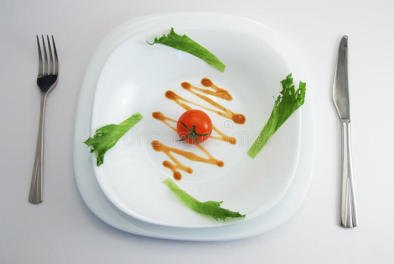 Tomato on white plate