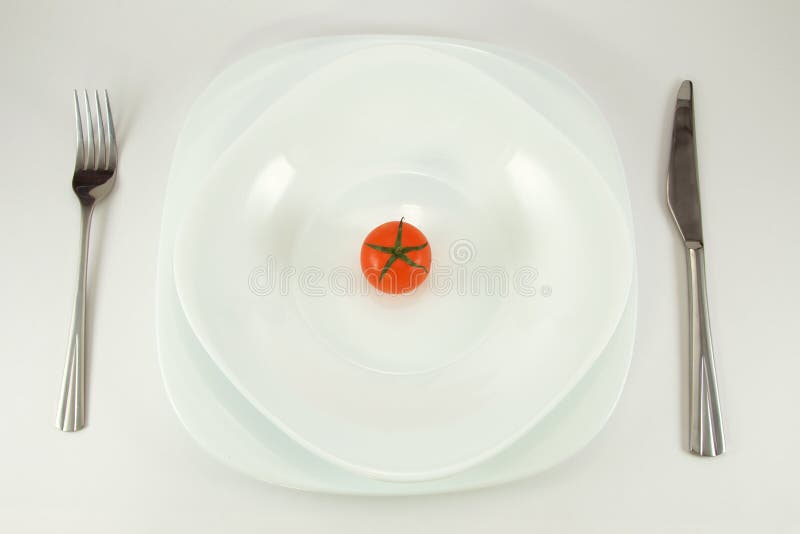 Tomato on white plate