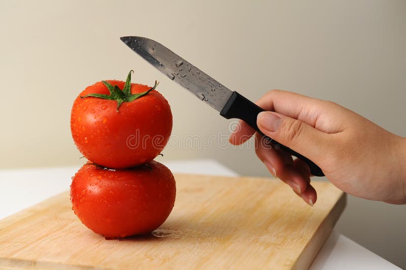 Tomatoes cut stock image. Image of water, hand, wooden 19337879