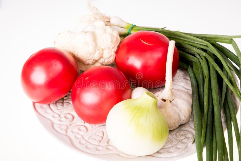 Tomatoes, Garlic, Onion and Chive on Plate Isolated Stock Photo Image