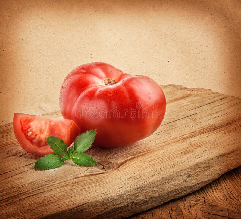 Tomatoes on the grunge yellow paper background