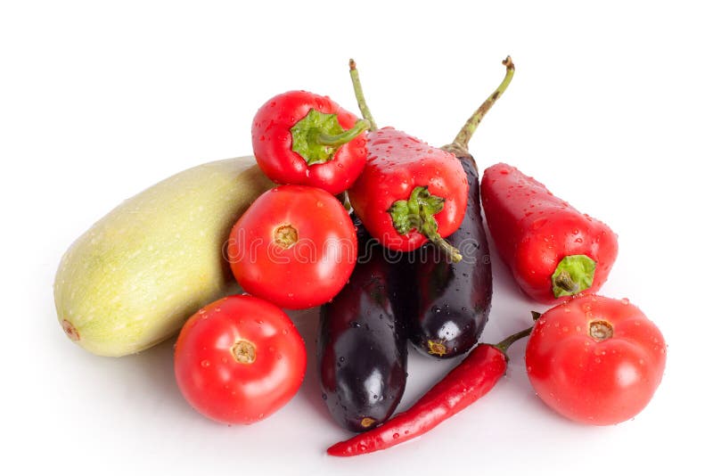 Tomatoes, red sweet peppers, red hot chilli peppers, violet eggplants, green zucchini in drops of water