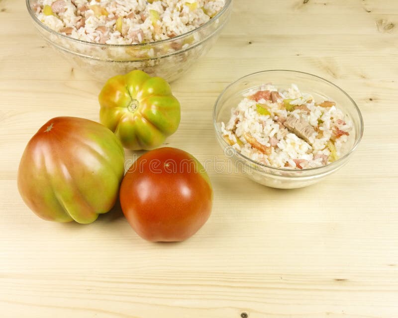 Tomatoes and Simple Rice Salad in a Transparent Bowl on Wood Stock