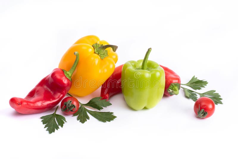 Tomatoes and sweet peppers on a white background. Red and yellow peppers on a white background. Tomatoes with colorful peppers in