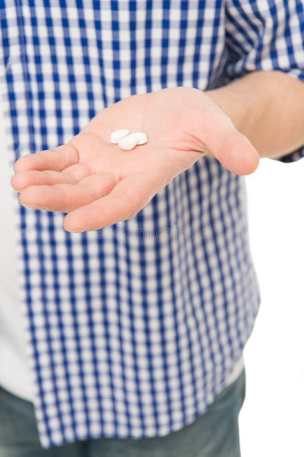 Tome este comprimido Comprimidos e drogas Comprimido ou vitamina da medicina na mão masculina Comprimidos brancos da vitamina Com imagem de stock royalty free Tome este comprimido Comprimidos e drogas Comprimido ou vitamina da medicina na mão masculina Comprimidos brancos da vitamina Com imagem de stock royalty free
