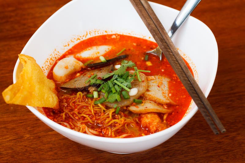 Tomyum noodle on wooden table