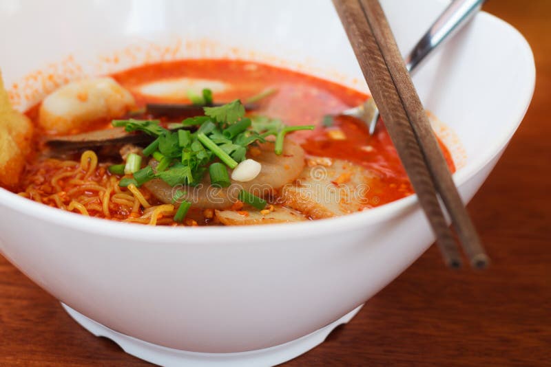 Tomyum noodle on wooden table