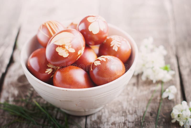 Easter Eggs on Wooden Table Decorated with Natural Fresh Leaves Stock