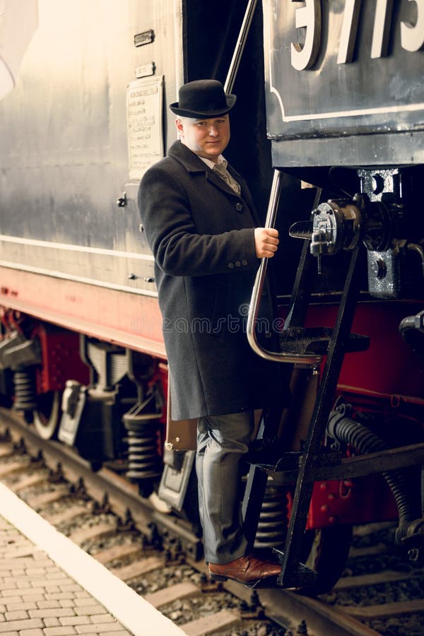 Man in Retro Suit with Suitcase Walking on the Train Platform Stock