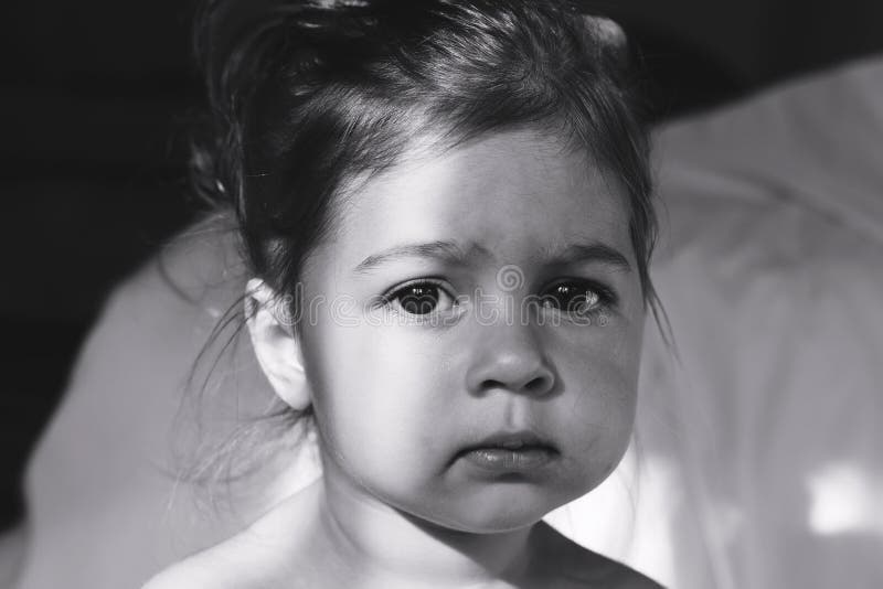 Toned Portrait of cute sad little girl thinking.