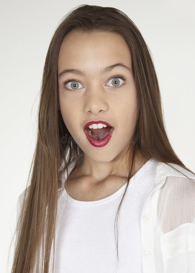 Portrait head shot of a teen girl against a white studio background. Portrait head shot of a teen girl against a white studio background