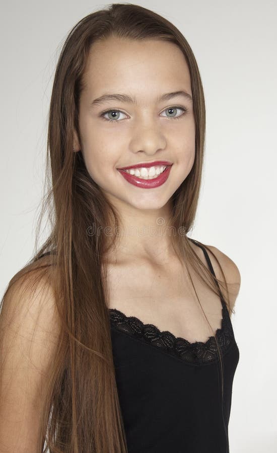 Portrait head shot of a teen girl against a white studio background. Portrait head shot of a teen girl against a white studio background